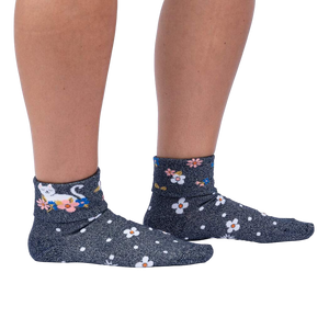 Another lifestyle shot of a person wearing the Sitting Kitty Turn Cuff socks, standing against a white background, from a slightly different angle.