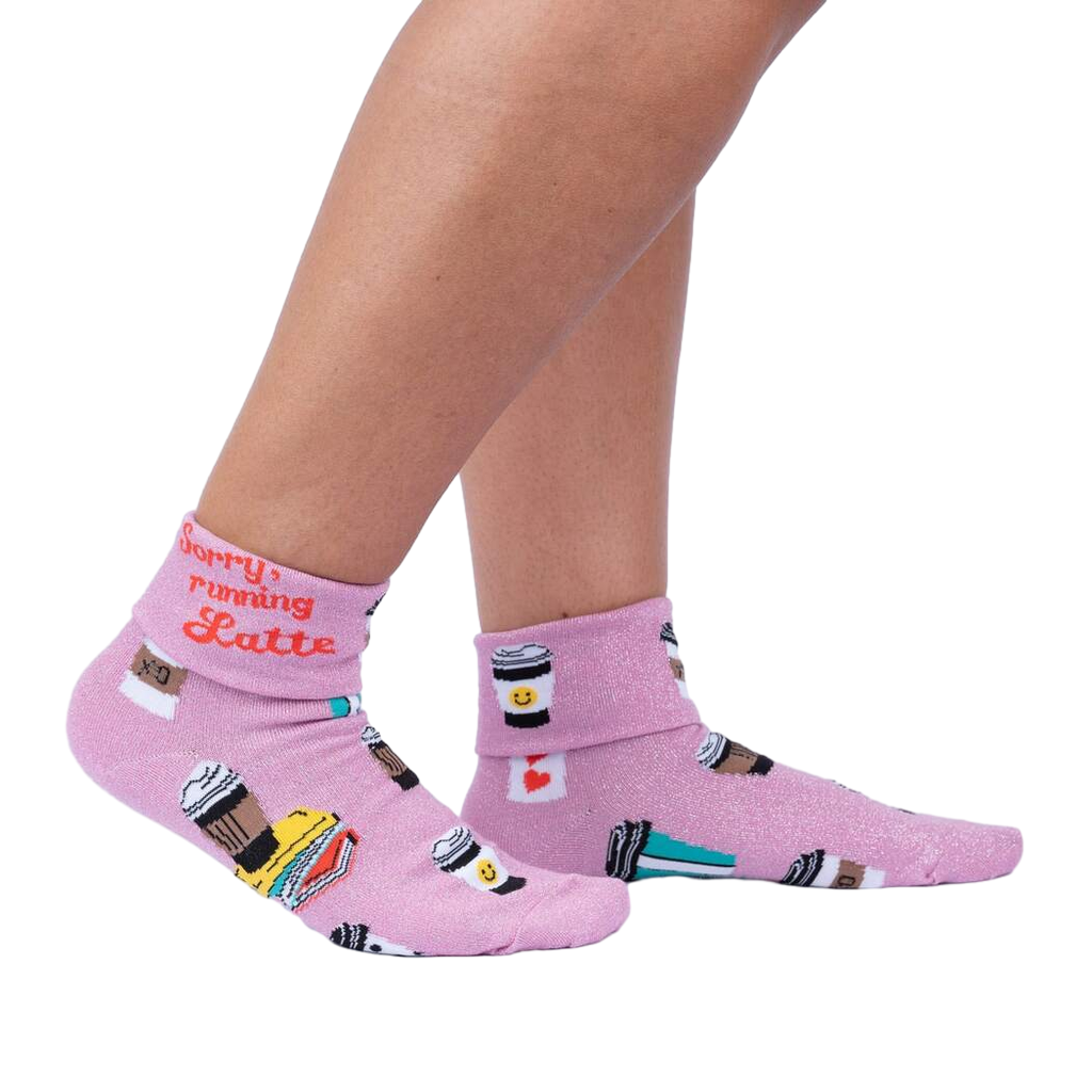 Lifestyle shot: Woman's legs wearing the 'Sorry Running Latte' socks, showing the design and fit.