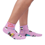 Lifestyle shot: Woman's legs wearing the 'Sorry Running Latte' socks, showing the design and fit.