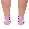 Back view of the socks on a person's legs, showcasing the rolled-down cuff message.