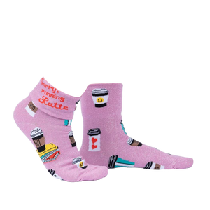 Another lifestyle shot of the socks, highlighting the pink glitter fabric and coffee cup designs.