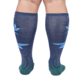 Rear view of model's legs wearing the teal and navy blue knee-high socks with dragonflies.