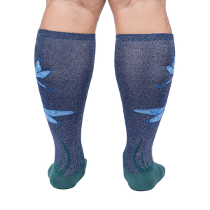 Rear view of model's legs wearing the teal and navy blue knee-high socks with dragonflies.