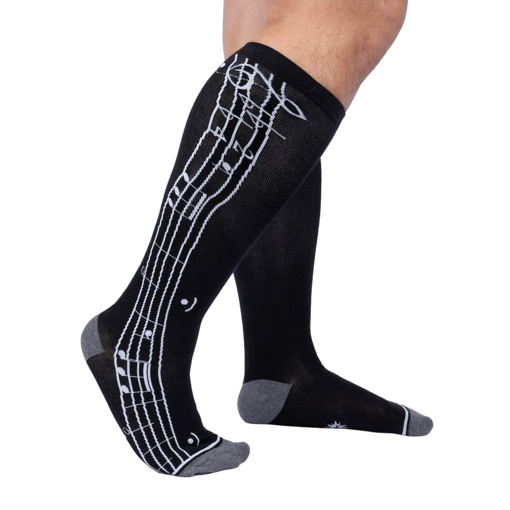 Lifestyle shot showing the 'Music Is My Forte' socks on a person's legs.
