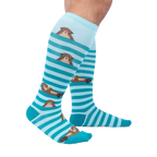 Lifestyle shot showcasing the 'My Otter Foot' knee-high socks on a model's legs, highlighting their fit and appearance.