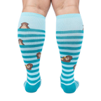 Back view of the 'My Otter Foot' socks on a model's legs, showing the full design and how the otters are positioned on the back of the leg.