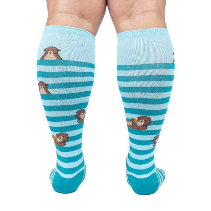 Back view of the 'My Otter Foot' socks on a model's legs, showing the full design and how the otters are positioned on the back of the leg.