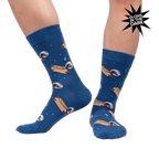 Lifestyle shot of a person wearing the 'Weiner Dogs, In Space!' socks, showcasing the glow-in-the-dark effect.