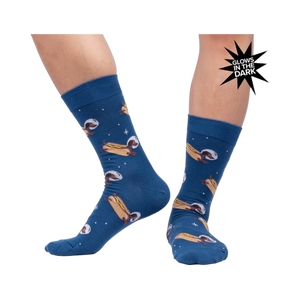 Lifestyle shot of a person wearing the 'Weiner Dogs, In Space!' socks, showcasing the glow-in-the-dark effect.