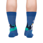 Back view of the socks on a person's legs, showcasing the design on the back of the socks.