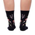 Close-up view of the back of the socks, highlighting the full mushroom pattern and text.