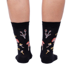 Close-up view of the back of the socks, highlighting the full mushroom pattern and text.