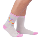 Lifestyle shot showcasing 'Keep It Weird!' socks on a person's legs, highlighting the fit and style.