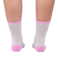 Rear view of 'Keep It Weird!' socks on a person's legs, showing the pink cuffs and subtle sock details.