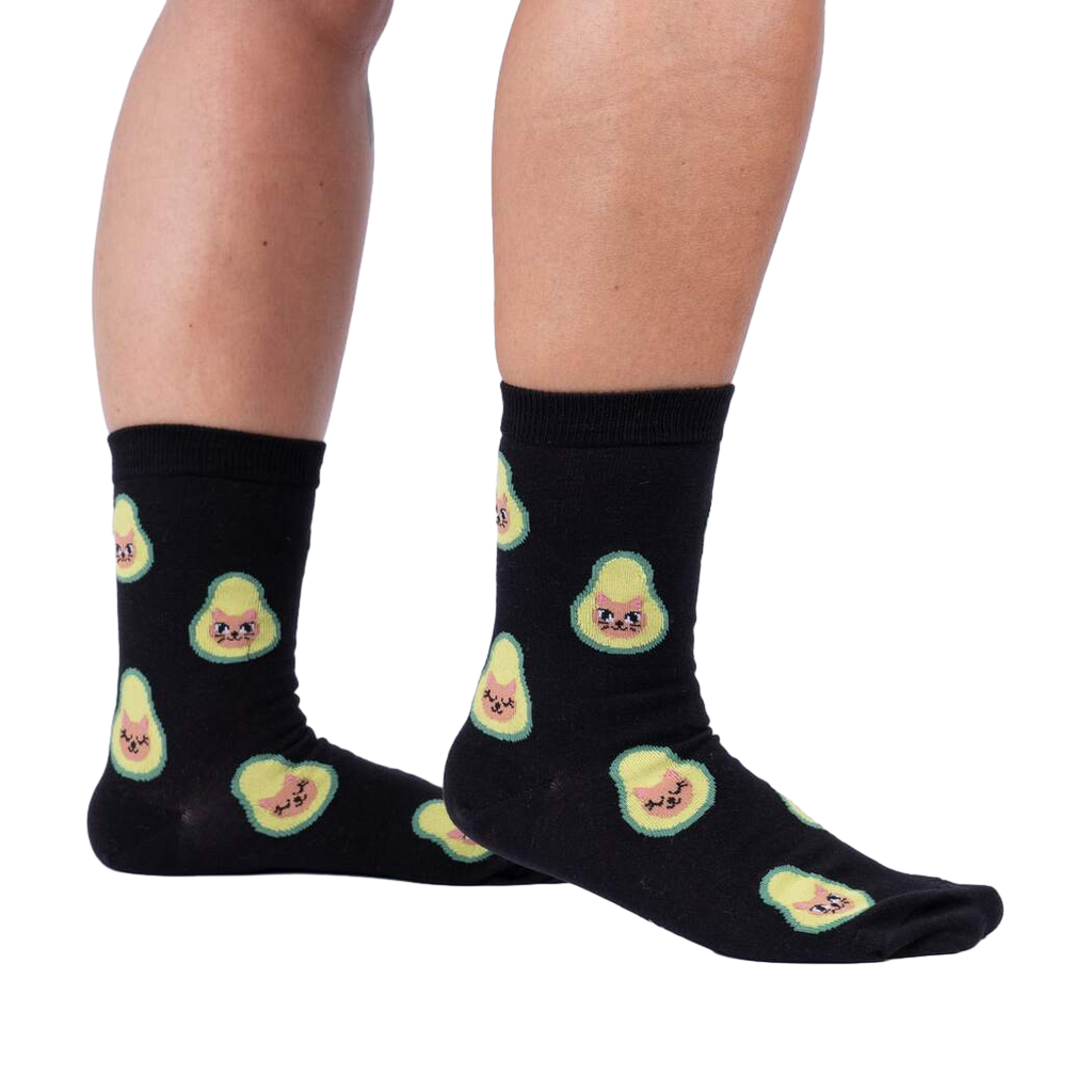 Lifestyle shot showing the socks on a person's legs.  The socks are black with a pattern of avocado cats.