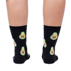Back view of the same socks shown on a person's legs.  The avocado-cat design is clearly visible from behind.