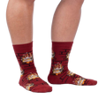 Lifestyle photo showing a person's legs wearing the Yule Log socks.