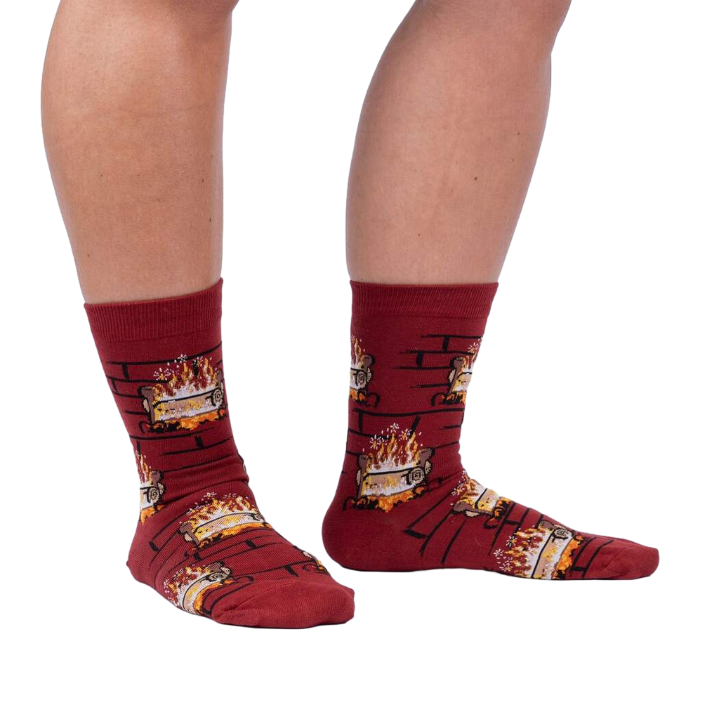 Lifestyle photo showing a person's legs wearing the Yule Log socks.