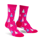 Pair of fuchsia crew socks with a pattern of pastel blue, pink, and green Christmas trees and white snowflakes.