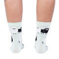 Back view of the socks, highlighting the full pattern design on the mint green fabric.