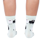 Back view of the socks, highlighting the full pattern design on the mint green fabric.