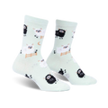 Pair of mint green crew socks featuring a repeating pattern of black and white sheep, some jumping a fence. 