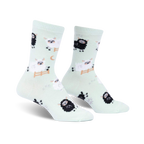 Pair of mint green crew socks featuring a repeating pattern of black and white sheep, some jumping a fence. 