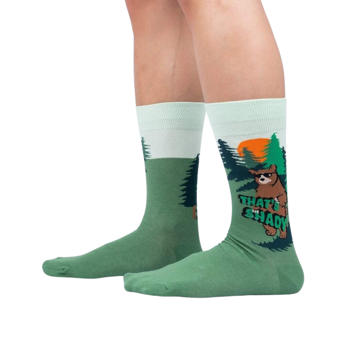 A pair of green socks with a cartoon bear wearing sunglasses and the text 