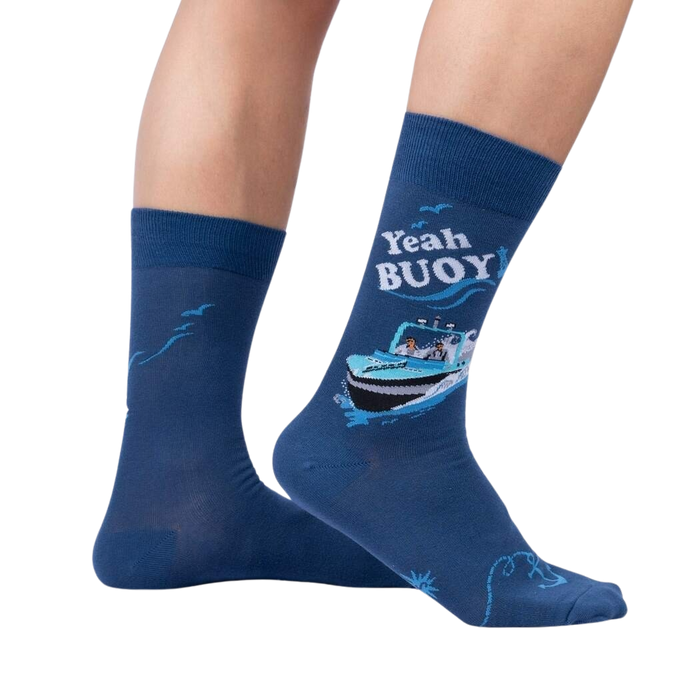 A pair of blue socks with a cartoon boat on them. The socks have the words 