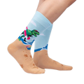 Lifestyle photo showing Dinos Gone Wild socks on a person's feet, showcasing the sock's fit and design on legs.