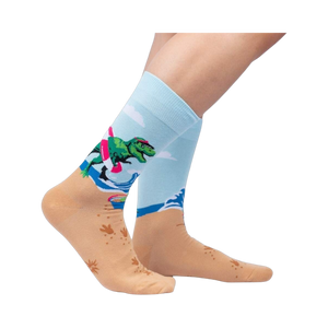 Lifestyle photo showing Dinos Gone Wild socks on a person's feet, showcasing the sock's fit and design on legs.