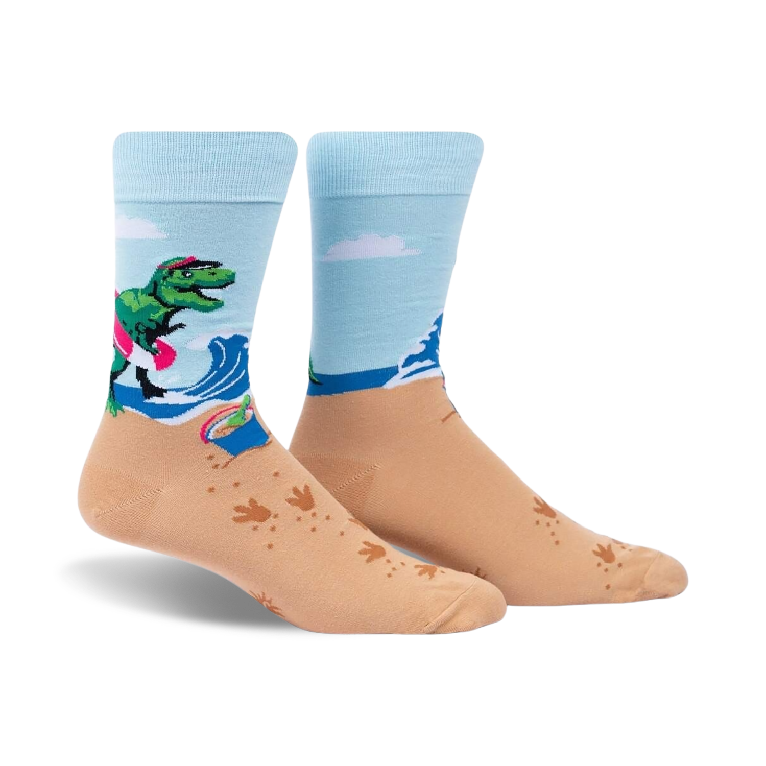 Crew socks in light blue and tan. Design features a T-Rex on a surfboard at the beach with wave and footprint details.