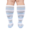 Back view of a person modeling the snowflake and stripe knee-high socks.