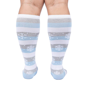 Back view of a person modeling the snowflake and stripe knee-high socks.