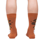 Rear view of the socks on a person's legs, highlighting the back design of the coffee cup and text.