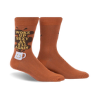Pair of brown crew socks with a funny 'Woke Up Sexy As Hell Again' slogan and coffee cup graphic. Dark brown coffee spill design element.