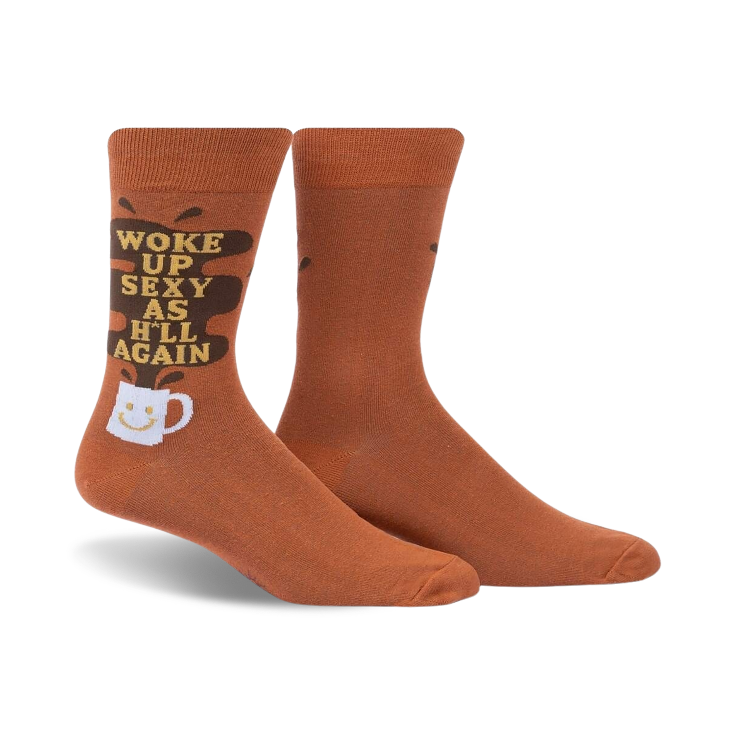 Pair of brown crew socks with a funny 'Woke Up Sexy As Hell Again' slogan and coffee cup graphic. Dark brown coffee spill design element.