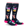 Pair of knee-high socks on a white background. Black background with pink, orange, and teal space cats, stars, and comets. Rainbow top cuff.