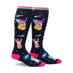 Pair of knee-high socks on a white background. Black background with pink, orange, and teal space cats, stars, and comets. Rainbow top cuff.
