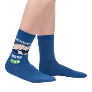 A pair of blue socks with a chihuahua on them. The chihuahua is sleeping on the word 