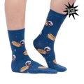 Lifestyle shot of a person wearing the Weiner Dogs, In Space! Glow in the Dark socks. The socks are partially visible.