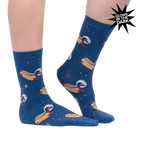 Lifestyle shot of a person wearing the Weiner Dogs, In Space! Glow in the Dark socks. The socks are partially visible.