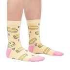 Lifestyle shot of a person's legs wearing the 'Butter Me Up' socks, showcasing the fit and overall style.