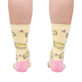 Rear view of the socks on a person's legs, highlighting the pink heel and toe details against the pastel yellow.