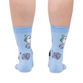 Close-up of the back of the light blue crew socks showcasing the cat and pill bottle design.