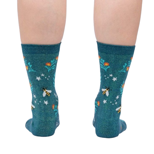 A pair of teal socks with a pattern of bees, flowers, and stars.