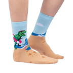 Lifestyle shot of Dinos Gone Wild socks on a person's feet, showcasing the beach-themed design.