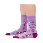 Lifestyle photo showcasing the 'Maybe Wine Will Help' socks on a person's legs.