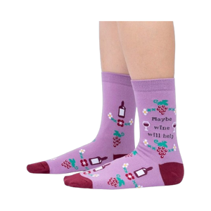 Lifestyle photo showcasing the 'Maybe Wine Will Help' socks on a person's legs.