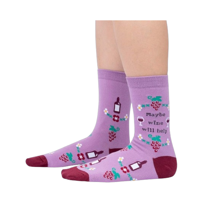 Lifestyle photo showcasing the 'Maybe Wine Will Help' socks on a person's legs.